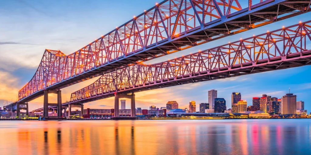 Crescent City Connection bridges and New Orleans skyline at sunset